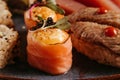 Colorful plate featuring a variety of sushi rolls, carrots, and cooked meat Royalty Free Stock Photo