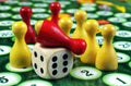 Colorful play figures with dice on black board. copy space Royalty Free Stock Photo