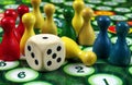 Colorful play figures with dice on black board. copy space Royalty Free Stock Photo