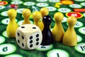 Colorful play figures with dice on black board. copy space Royalty Free Stock Photo