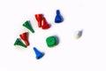 Colorful play figures and plastic chips with dice on white background. Board games for children and adults. Family and friendly Royalty Free Stock Photo