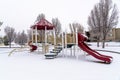 Colorful playground for children at a park covered with snow at winter season Royalty Free Stock Photo