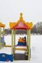 Colorful Playground in the form of a house or gazebo in the amusement Park, winter, snow, vertical frame Royalty Free Stock Photo