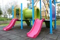 Colorful playground in public park, slide and swing on yard activities for children. Royalty Free Stock Photo