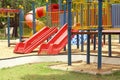 Colorful playground in public park, slide and swing on yard activities for children Royalty Free Stock Photo