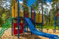 Colorful playground on yard in the summer park. Royalty Free Stock Photo