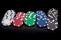 Colorful playing chips in rows on dark background