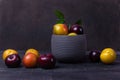 Colorful plums fruit in pot and plate Royalty Free Stock Photo