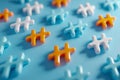 Colorful plus-shaped objects in white, blue, and orange scattered on a soft blue background creating a vibrant and modern pattern Royalty Free Stock Photo