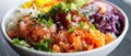 Colorful poke bowl with fresh vegetables, tuna, salmon, and garnishes.