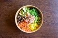 Colorful poke bowl salad with rice, carrots, edamame, radish and mushrooms