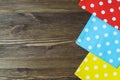 Colorful polka dot napkins on wooden background.