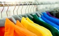 Colorful polo shirts on hangers