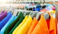 Colorful polo shirts on hangers