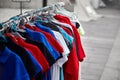 Colorful polo t-shirts for the man on hangers in a store. Street sale of male clothes Royalty Free Stock Photo