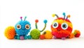 Colorful pom-pom creatures sit together on a white background