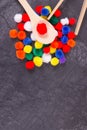 Colorful pompoms using for development of kids motor skills, coordination and logical thinking. Place for text