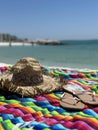 Colorful poncho, sombrero and sandals on the beach