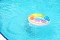 A colorful pool float bobs in tranquil water, capturing a serene summer vibe. This scene reflects leisure and the joy of