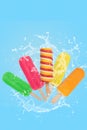 Colorful popsicles ice cream on blue background with splash. vertical format
