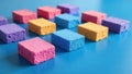 Colorful porous blocks arranged in a grid pattern on a vibrant blue surface. Generative AI Royalty Free Stock Photo