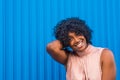 Colorful portrait of African and American young woman smiling and looking at the camera having fun with blue beautiful color Royalty Free Stock Photo