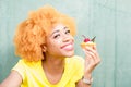 Colorful portrait of an african woman with sweet dessert Royalty Free Stock Photo