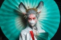 Colorful portrait of cute woman face in animal mask and creative makeup. Halloween, Carnival and Cosplay concept Royalty Free Stock Photo