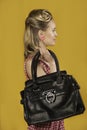 Colorful portrait of a retro pin-up girl with a black leather handbag Royalty Free Stock Photo