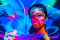 Colorful portrait of woman with projector multicolor light illumination