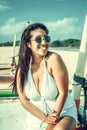 Colorful portrait of young attractive asian woman in white dress on the tropical beach of Bali island, Indonesia.