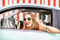 Woman in the car on red wall background Royalty Free Stock Photo