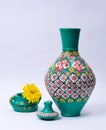 Colorful pottery vase, lid, green pottery cup and yellow flower