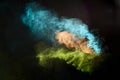 Colorful powder exploding creating abstract green turquoise orange forms Royalty Free Stock Photo