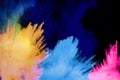 Colorful powder explosion cloud on black background. Freeze motion of color dust  particles splash Royalty Free Stock Photo