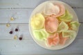 Colorful prawn cracker in white plate, top view of candies and shrimp crackers