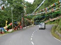 Colorful Prayer Flags Flutter Amid Vehicle Passing Away