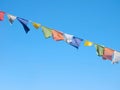 Colorful prayer flags over a clear blue sky in India