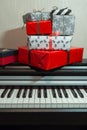 Colorful present boxes on the piano. Christmas decoration of Interior.