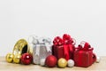 Colorful present boxes on a table over the light wall. Royalty Free Stock Photo