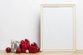 Colorful present boxes with a white photo frame on a wooden table. Royalty Free Stock Photo