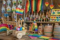 Colorful Pride celebration with wooden floats, rainbow flags, and supportive signs on a wooden background