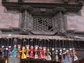 Colorful puppets hang from the wall of an old building on a street in central Kathmandu. Nepal Royalty Free Stock Photo