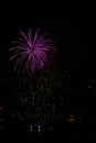 Colorful Purple Fireworks Over City Skyline and River Royalty Free Stock Photo