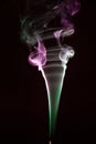 Colorful smoke of incence stick isolated at black background Royalty Free Stock Photo