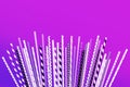 Colorful purple straws collections on pastel background.