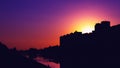 Colorful purple sunset and buildings in the dark shade