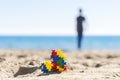 Colorful puzzle autism awareness heart on beach sand and back view to silhouette of the child walk away to the sea ocean