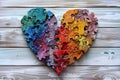 Colorful puzzle heart on grey wooden background Royalty Free Stock Photo