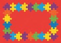 Colorful puzzle pieces form a rectangular border against a red backgroun Royalty Free Stock Photo